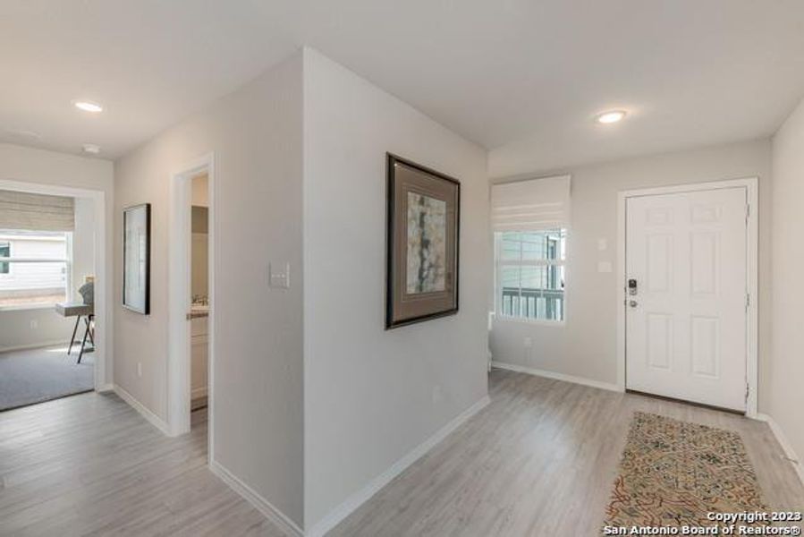 Foyer entrance featuring light wood-type flooring, healthy amount of natural light, and recessed lighting Foyer entrance featuring light wood-type flooring, healthy amount of natural light, and recessed lighting