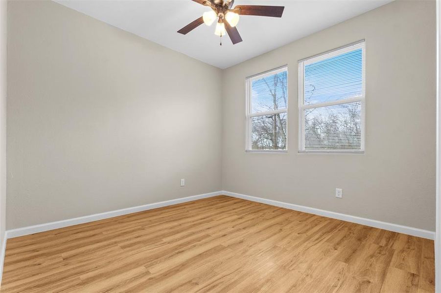 Spare room featuring light wood-style floors and a ceiling fan