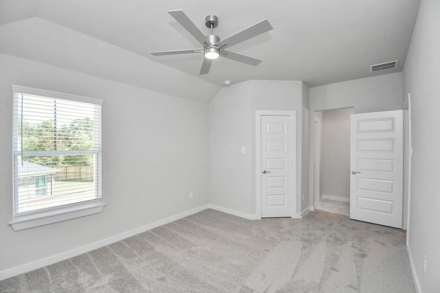 Generously sized secondary bedrooms featuring spacious closets, soft and inviting carpeting underfoot, large windows allowing plenty of natural light, and the added touch of privacy blinds for your personal retreat. Sample photo of completed home with similar floor plan. Actual colors and selections may vary.