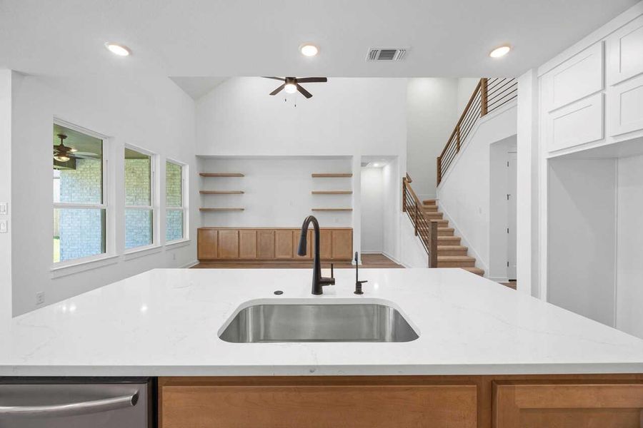Kitchen featuring recessed lighting, light stone countertops, a ceiling fan, dishwasher, and a kitchen island with sink Kitchen featuring recessed lighting, light stone countertops, a ceiling fan, dishwasher, and a kitchen island with sink