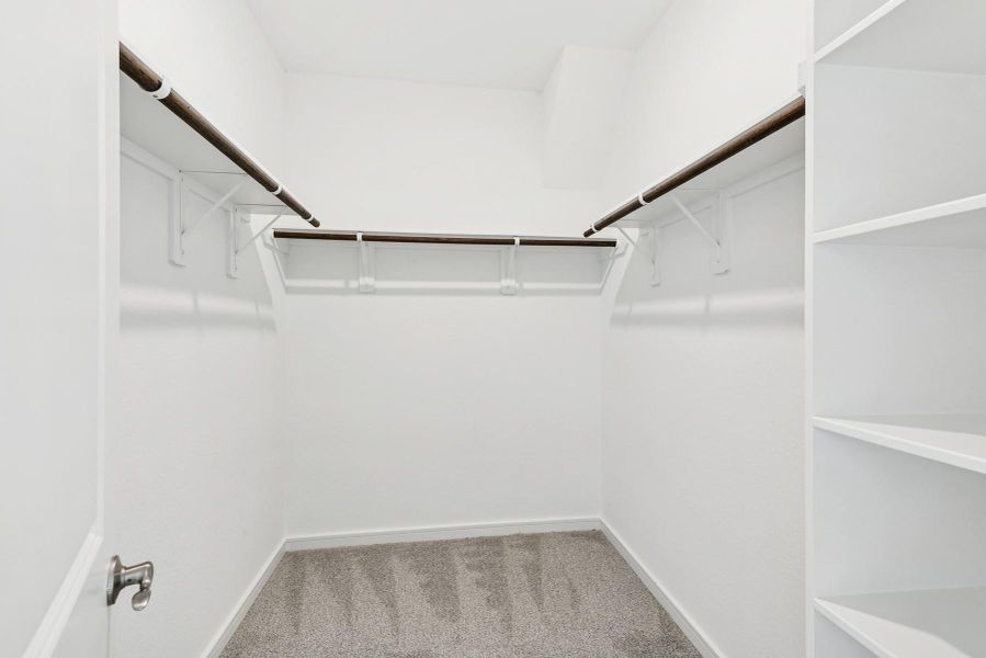 Walk-in closet in the primary suite Walk-in closet in the primary suite