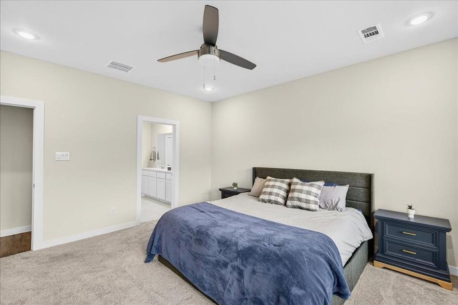 Bedroom with recessed lighting, carpet floors, a ceiling fan, and connected bathroom