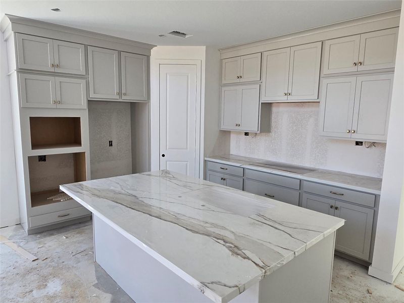 Kitchen with Stacked Cabinets and Porcelain Countertops