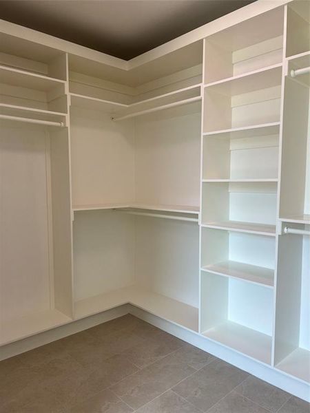Primary Walk in closet featuring light tile patterned floors