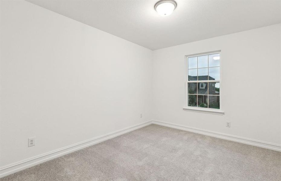 Comfortable secondary bedroom with generous closet space *Real home pictured