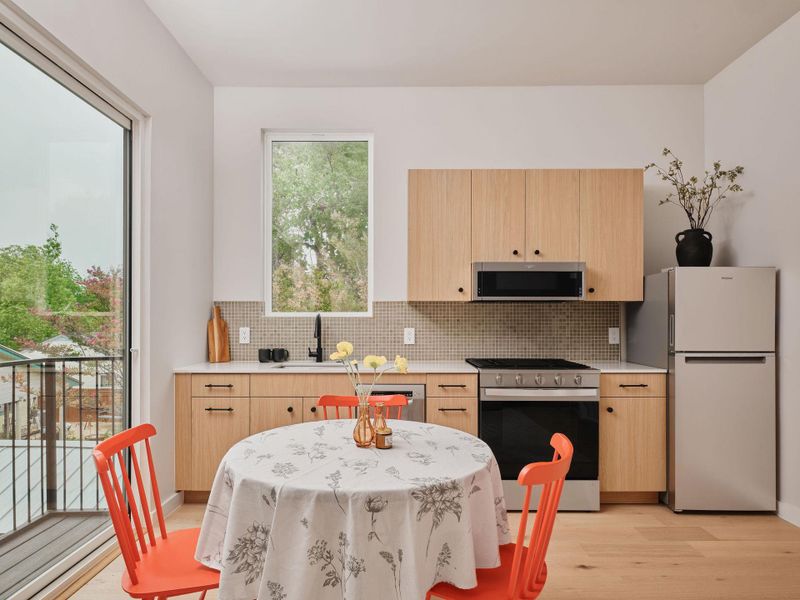 Modern kitchen featuring wood-finish cabinetry and a mosaic tile backsplash