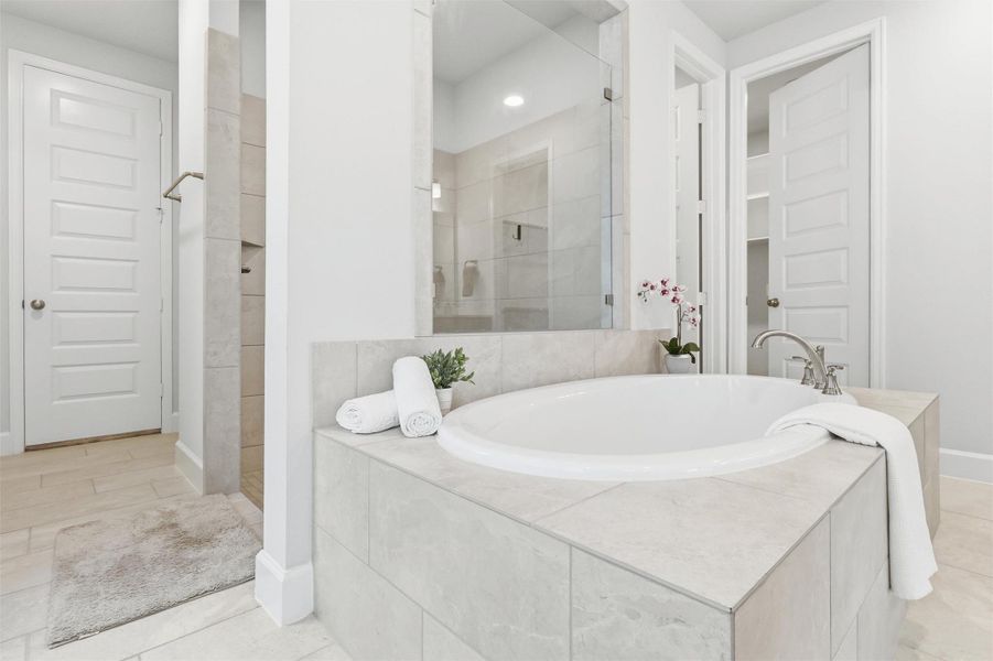 Every detail of the primary bath has been thoughtfully designed, from the oversized soaking tub and spacious shower to the seamless flow into the expansive walk-in closet, creating a true owner's retreat.