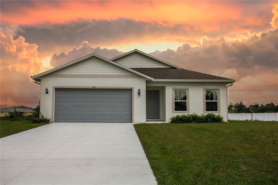 Front exterior of a new home in , Lehigh Acres, FL, highlighting curb appeal (Image 2). Front exterior of a new home in , Lehigh Acres, FL, highlighting curb appeal (Image 2).