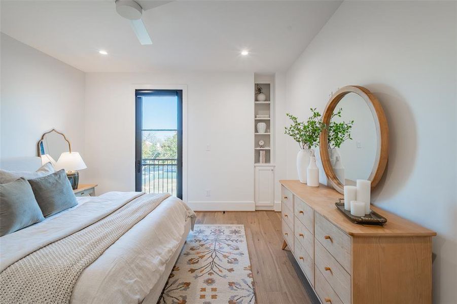 Bedroom with ceiling fan, light hardwood / wood-style floors, and access to outside