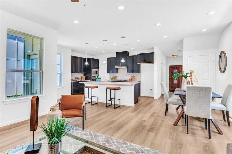 Dining area with light hardwood / wood-style floors and plenty of natural light