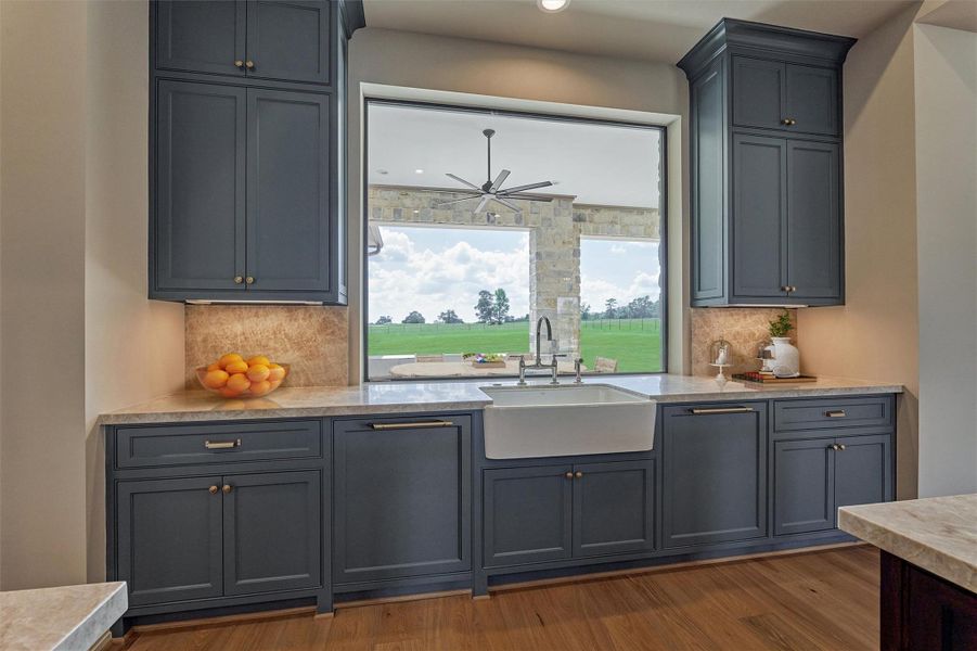 Farm sink, under counter lighting with views to back yard. Photo is virtually staged/enhanced. Farm sink, under counter lighting with views to back yard. Photo is virtually staged/enhanced.