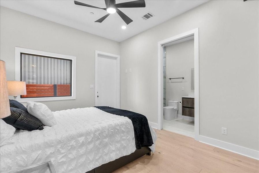 The first-floor bedroom feels warm and inviting with light-toned flooring, thoughtful designer details, and its own private high-end luxury bathroom. The first-floor bedroom feels warm and inviting with light-toned flooring, thoughtful designer details, and its own private high-end luxury bathroom.