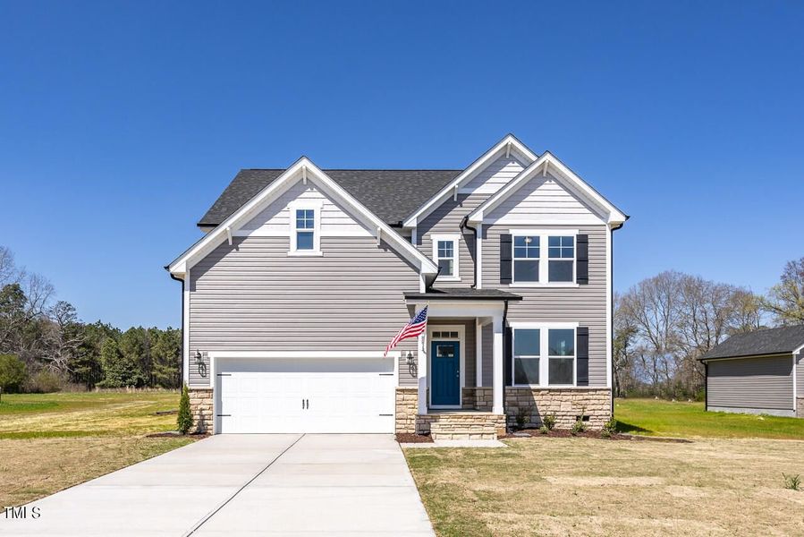 Front exterior of a new home in Wellers Knoll, Lillington, NC, highlighting curb appeal (Image 1). Front exterior of a new home in Wellers Knoll, Lillington, NC, highlighting curb appeal (Image 1).