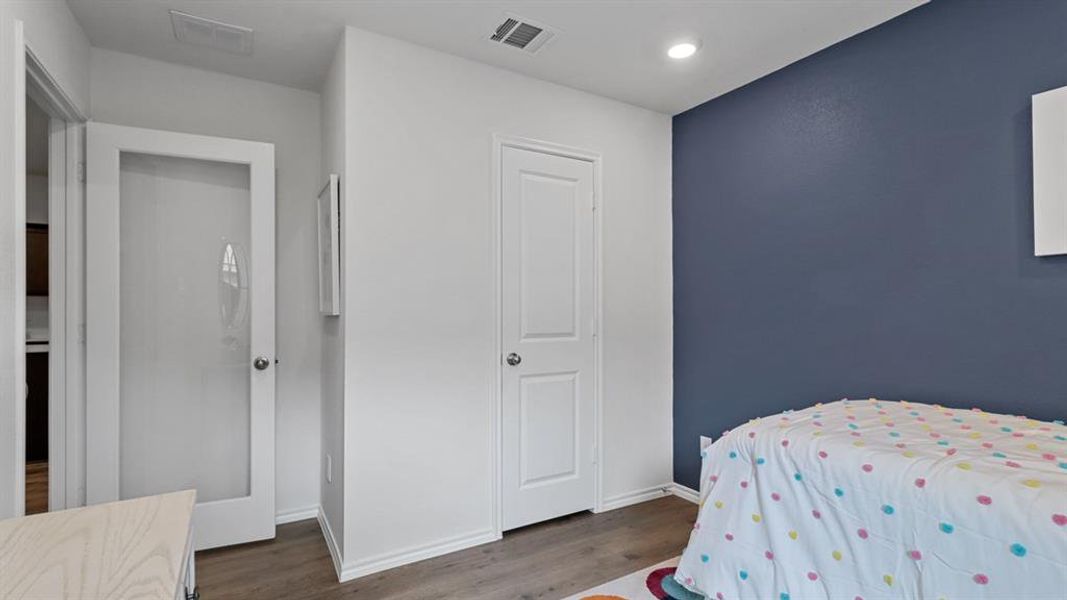 Bedroom with dark wood-style floors and recessed lighting Bedroom with dark wood-style floors and recessed lighting