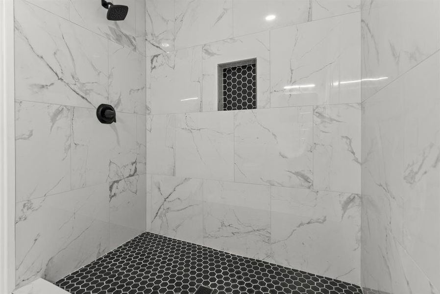 Primary bathroom featuring a tile shower