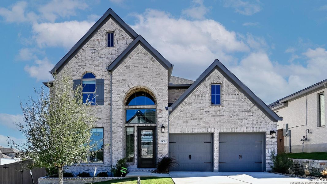 Front exterior of a new home in Johnson Ranch 55', Bulverde, TX, highlighting curb appeal (Image 1). Front exterior of a new home in Johnson Ranch 55', Bulverde, TX, highlighting curb appeal (Image 1).