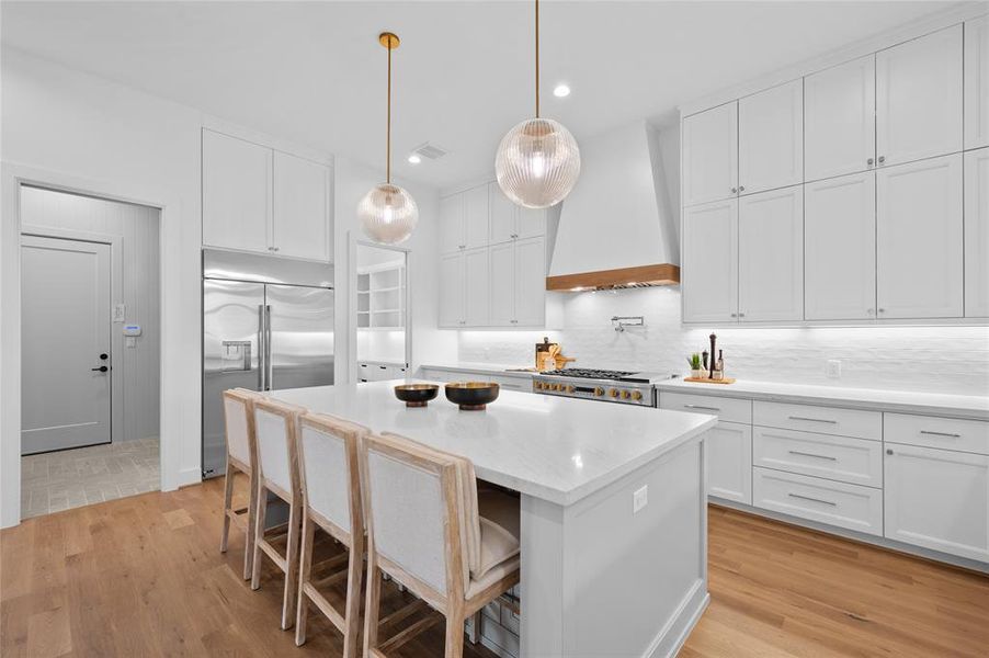 Beautiful chef's kitchen with 48" range and 48" built in fridge and windows overlooking backyard. Notice mudroom entrance from garage into kitchen with hidden pocket door that can hide mudroom clutter.