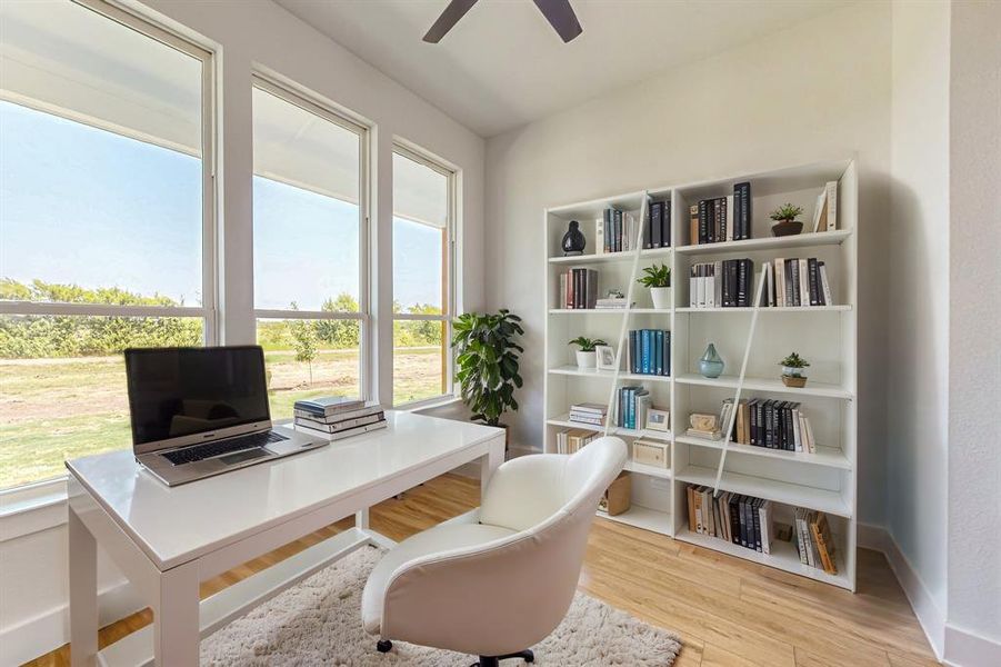 Office area with ceiling fan and light hardwood / wood-style flooring