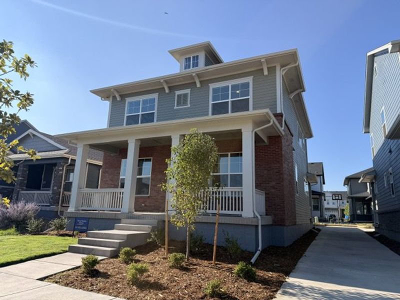 Front exterior of a new home in Painted Prairie Cottage Collection, Aurora, CO, highlighting curb appeal (Image 24).