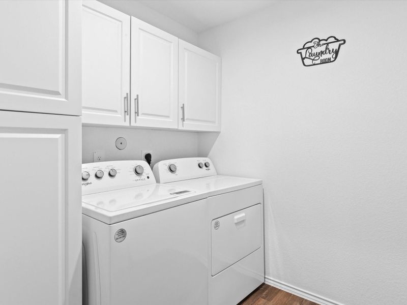 Spacious laundry room with upgraded built in cabinets.  Washer and Dryer is included.