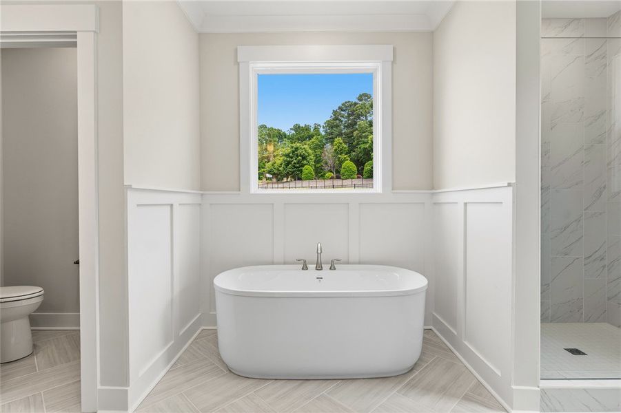 A spacious bathroom boasts a luxurious soaking tub