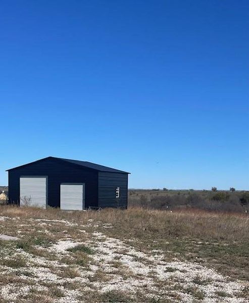 View of outbuilding featuring a garage