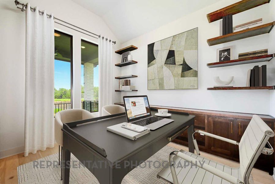 Home office featuring light wood-style flooring and vaulted ceiling Home office featuring light wood-style flooring and vaulted ceiling