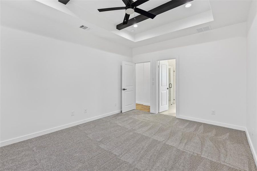 Unfurnished room featuring recessed lighting, light colored carpet, visible vents, and baseboards