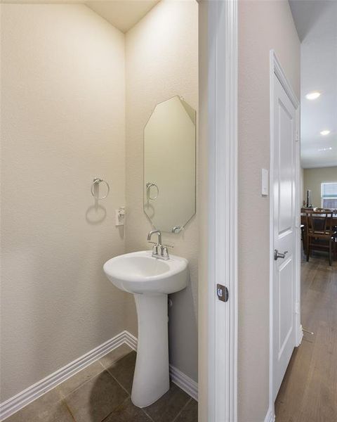 Pedestal sink with chrome faucet and an octagonal mirror Pedestal sink with chrome faucet and an octagonal mirror
