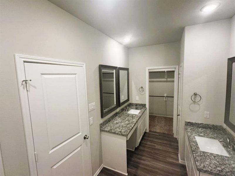 Her sink features knee space, granite counters & framed mirrors