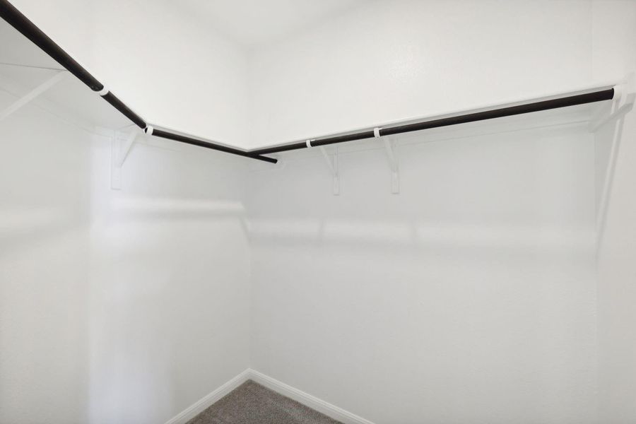 Primary bedroom walk-in closet