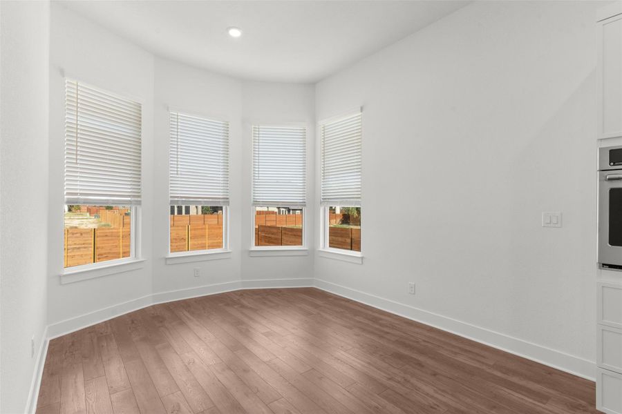 Unfurnished room featuring dark wood-style flooring and recessed lighting