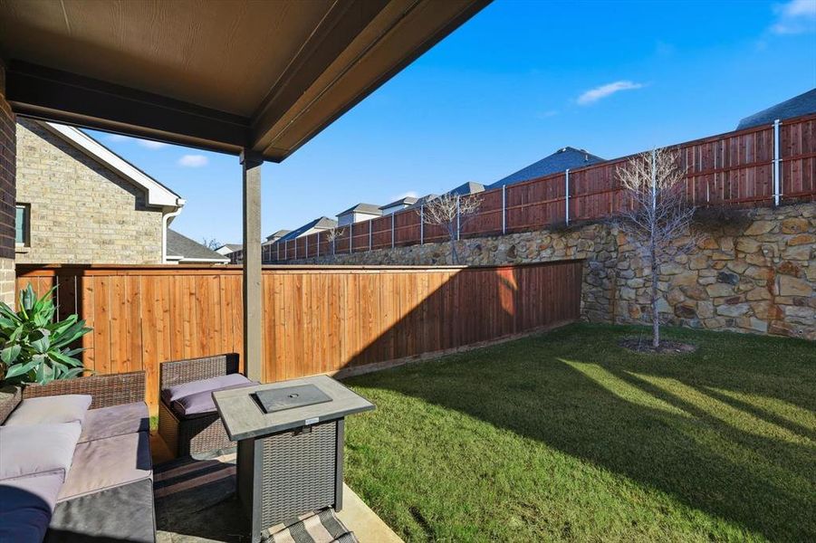 Fenced backyard with a patio area
