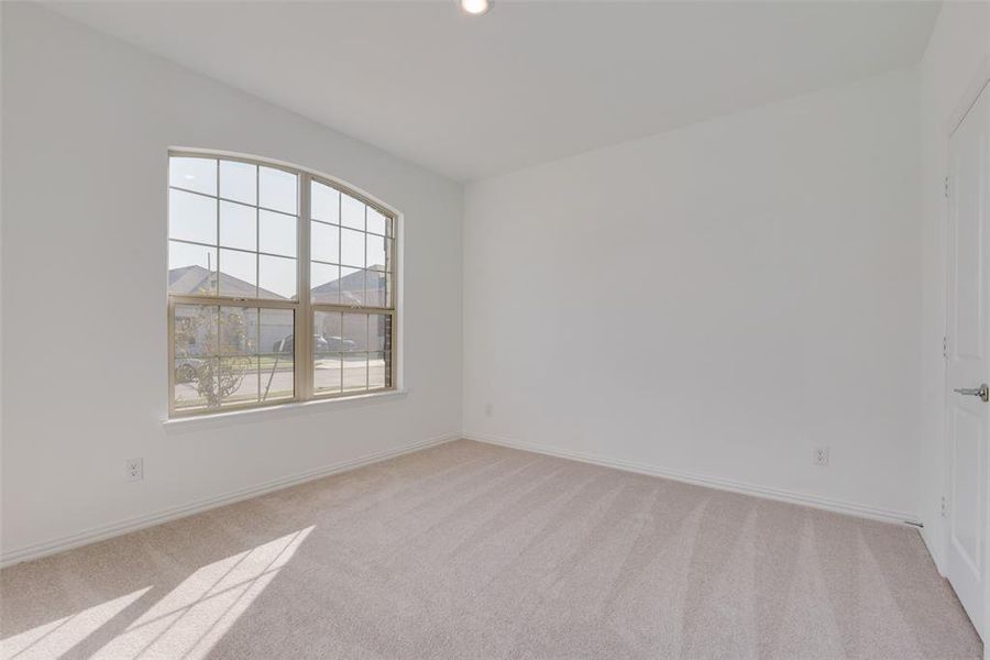 Empty room with light colored carpet