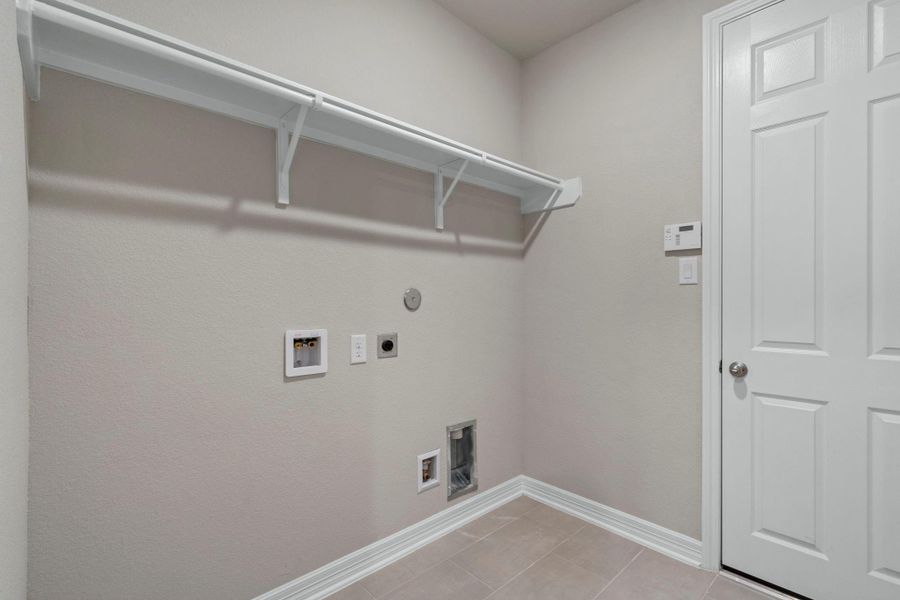 The laundry room layout is carefully planned for optimal workflow with designated areas for washing, drying, and storing. The laundry room layout is carefully planned for optimal workflow with designated areas for washing, drying, and storing.