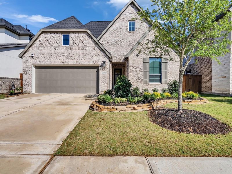 Front exterior of a new home in Tompkins Reserve, Katy, TX, highlighting curb appeal (Image 24).