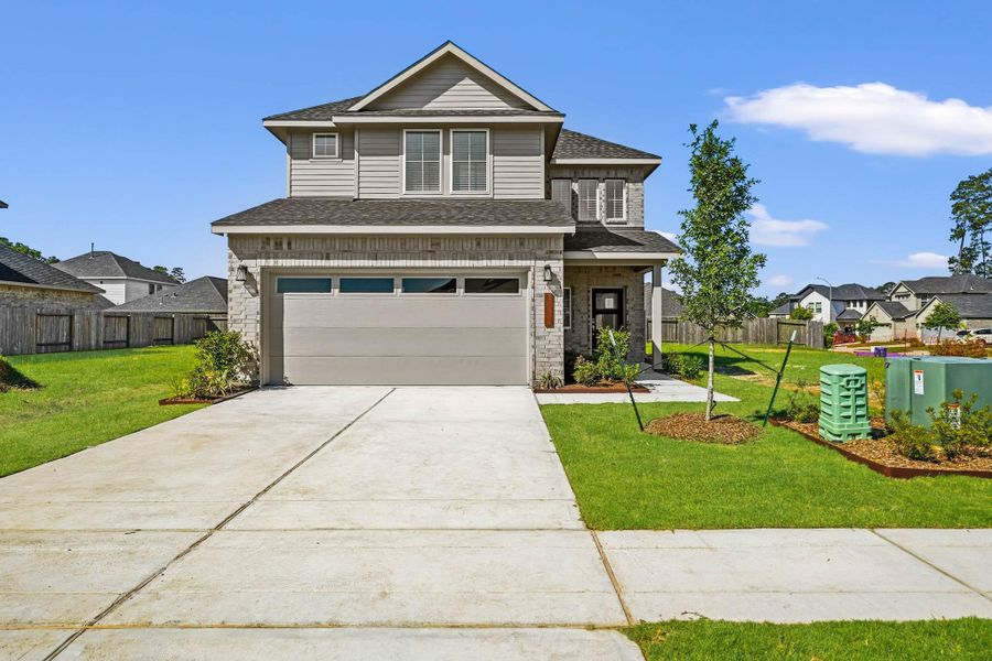 Front exterior of a new home in Audubon, Magnolia, TX, highlighting curb appeal (Image 1). Front exterior of a new home in Audubon, Magnolia, TX, highlighting curb appeal (Image 1).