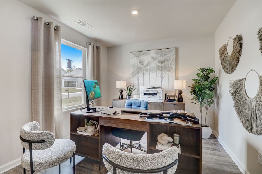 A room with a table and chairs.