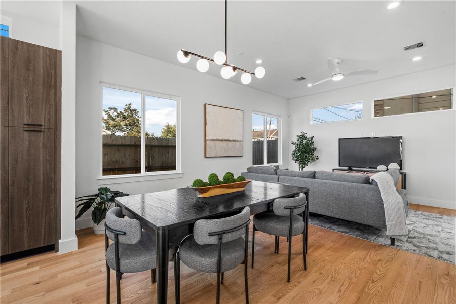 Inviting dining area anchored by a chandelier & surrounded by large windows that bring in beautiful natural light, perfect for everyday meals or hosting family and friends. Inviting dining area anchored by a chandelier & surrounded by large windows that bring in beautiful natural light, perfect for everyday meals or hosting family and friends.