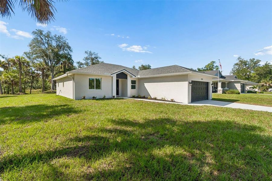Front exterior of a new home in , North Port, FL, highlighting curb appeal (Image 19). Front exterior of a new home in , North Port, FL, highlighting curb appeal (Image 19).