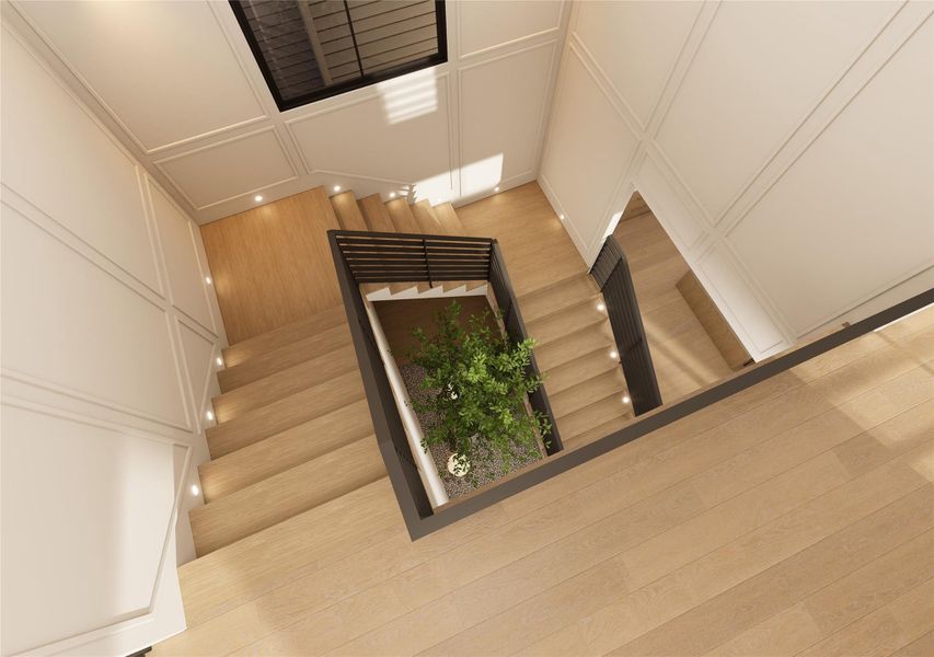 Viewed from the upper level, the stairwell becomes a design feature in its own right—clean lines intersecting with soft panel molding and layered illumination. At its core, a thoughtfully placed indoor planting bed introduces a calming, nature-infused counterpoint to the home’s tailored structure. Viewed from the upper level, the stairwell becomes a design feature in its own right—clean lines intersecting with soft panel molding and layered illumination. At its core, a thoughtfully placed indoor planting bed introduces a calming, nature-infused counterpoint to the home’s tailored structure.