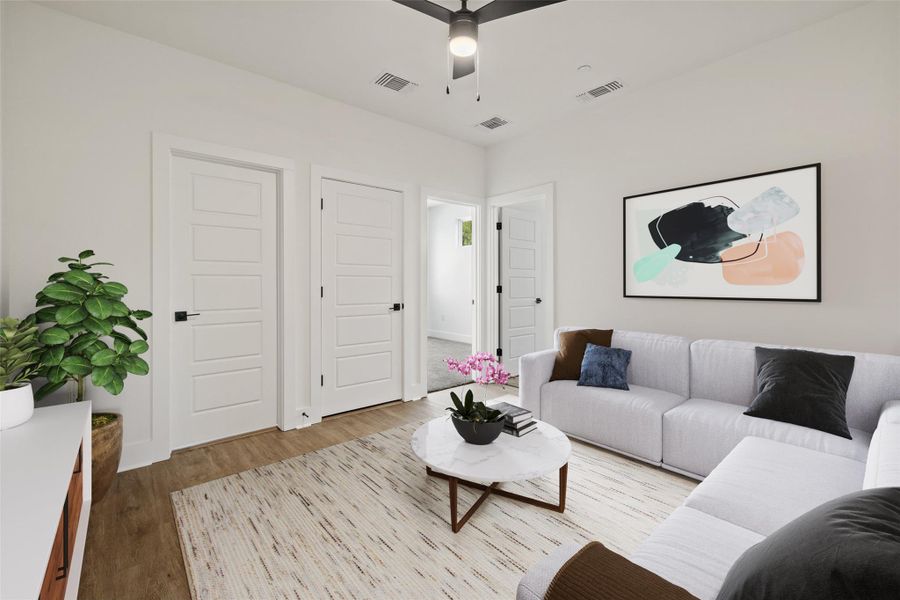 Upstairs living room featuring wood finished floors and a ceiling fan Upstairs living room featuring wood finished floors and a ceiling fan