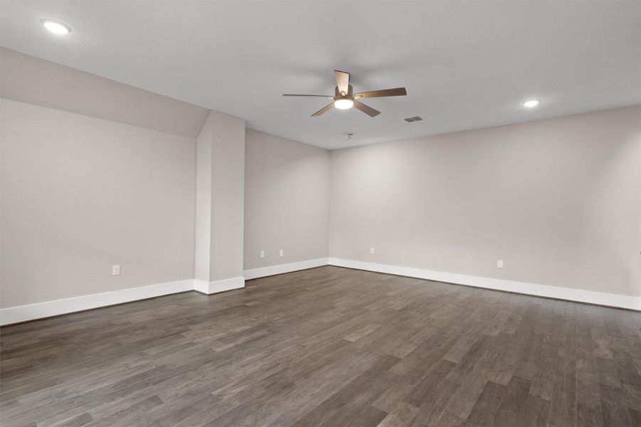 A spacious room offers resilient wood-look flooring and modern recessed lighting. A spacious room offers resilient wood-look flooring and modern recessed lighting.