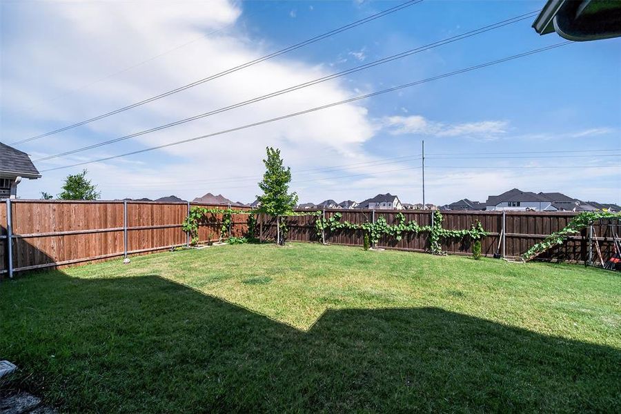 Fenced backyard featuring a residential view Fenced backyard featuring a residential view