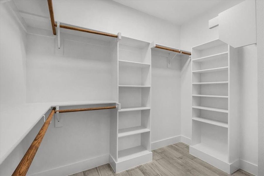 Walk in closet featuring wood finished floors