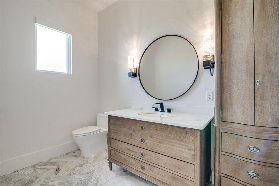 Powder bathroom with toilet and vanity