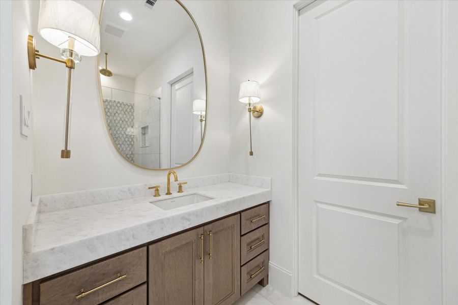 Second vanity space also has an oversized mirror and additional storage.