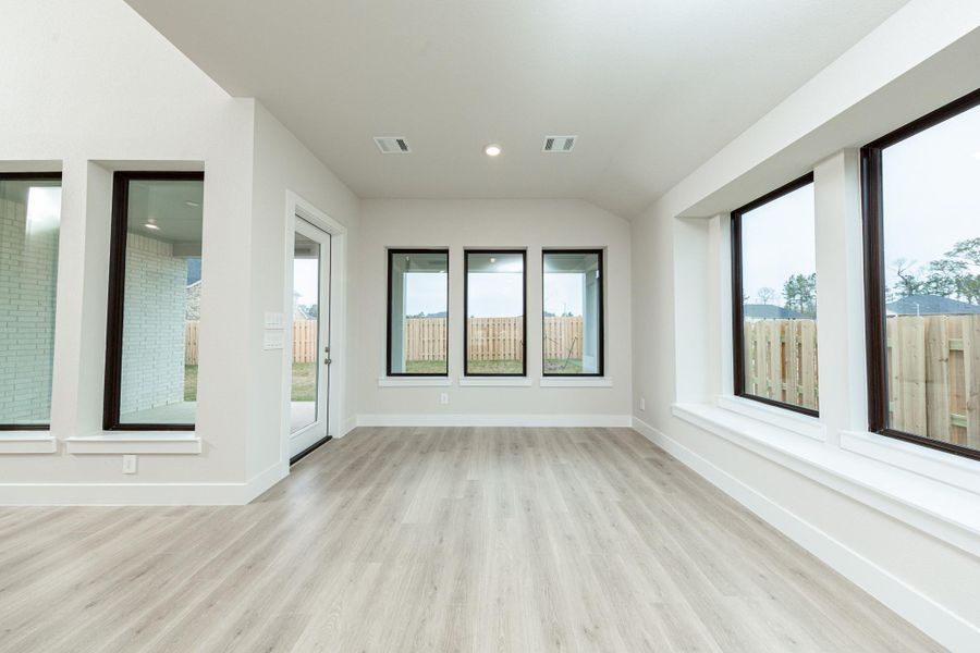 Create lasting memories around the table with family and friends in the dining! It showcases high ceilings, large windows with seating sill, laminate flooring, and recessed lighting for a warm and welcoming atmosphere.