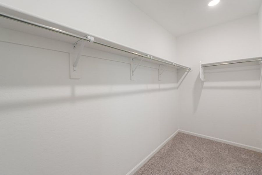 A white wall with a metal bar.