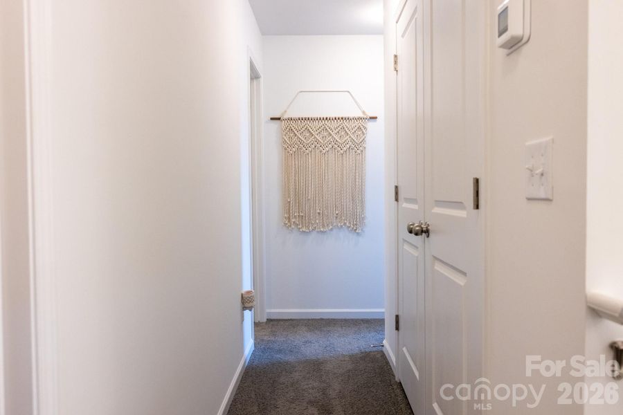 Second floor hallway with utility room on the right Second floor hallway with utility room on the right
